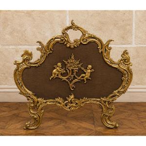 Large Gilded Bronze Fireplace Screen With Putti Motifs And Openwork Rocaille Decoration