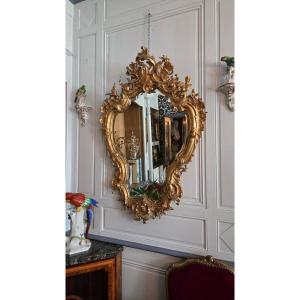 Rocaille Mirror Made Of Wood And Gilded Stucco, Decorated With Birds And A Gallant Trophy, 19th Century.