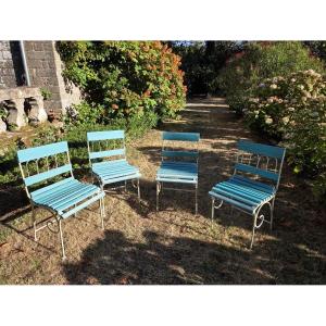 Quatre chaises pliantes de jardin en fer forgé