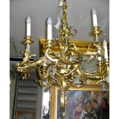 LUSTRE EN BRONZE A 8 BRAS DE LUMÈRE, SIGNÉ LUPPENS. RÉF:208