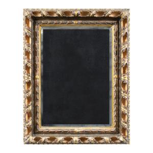 Miroir Art Nouveau en bois sculpté et doré. Italie, XXe siècle.