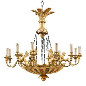 Lustre italien à douze lumières en bois sculpté, doré et peint. Début du XIXe siècle.