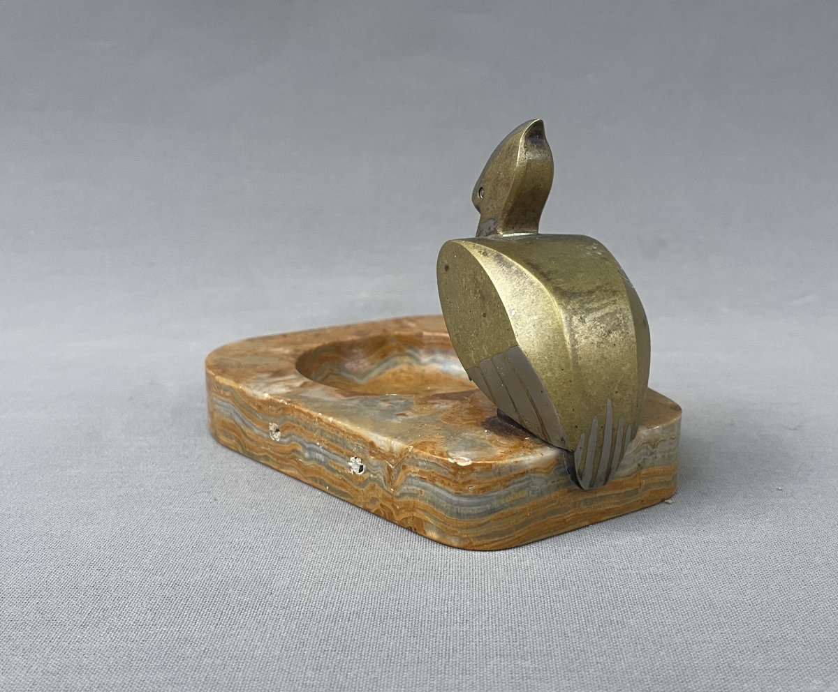 Empty Pocket Topped With A Bronze Pelican-photo-1