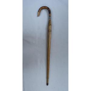 Canne trompe-l'oeil à limitation d'un parapluie