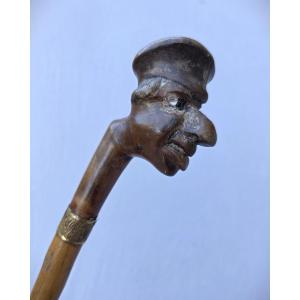 Canne art populaire caricature, homme à casquette et gros nez