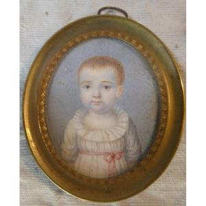 Miniature d'un bébé dans un cadre doré (vers 1840)